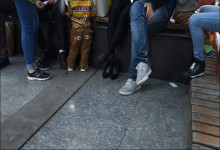 She Sit Down with Family to Rest a Walk while Looking and Play Shoe